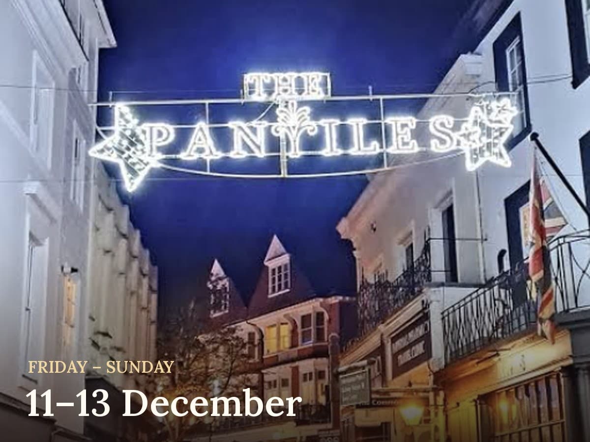 The Pantiles in Tunbridge Wells at night, with its lit-up sign over the street, Friday to Sunday 11–13 December